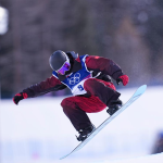 A snowboarder performs a trick during the Winter Olympics halfpipe qualification.